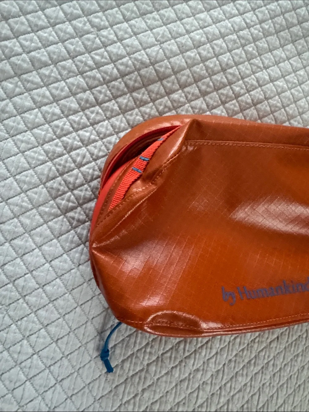 Humankind Orange Zip Travel Pouch with Blue Logo